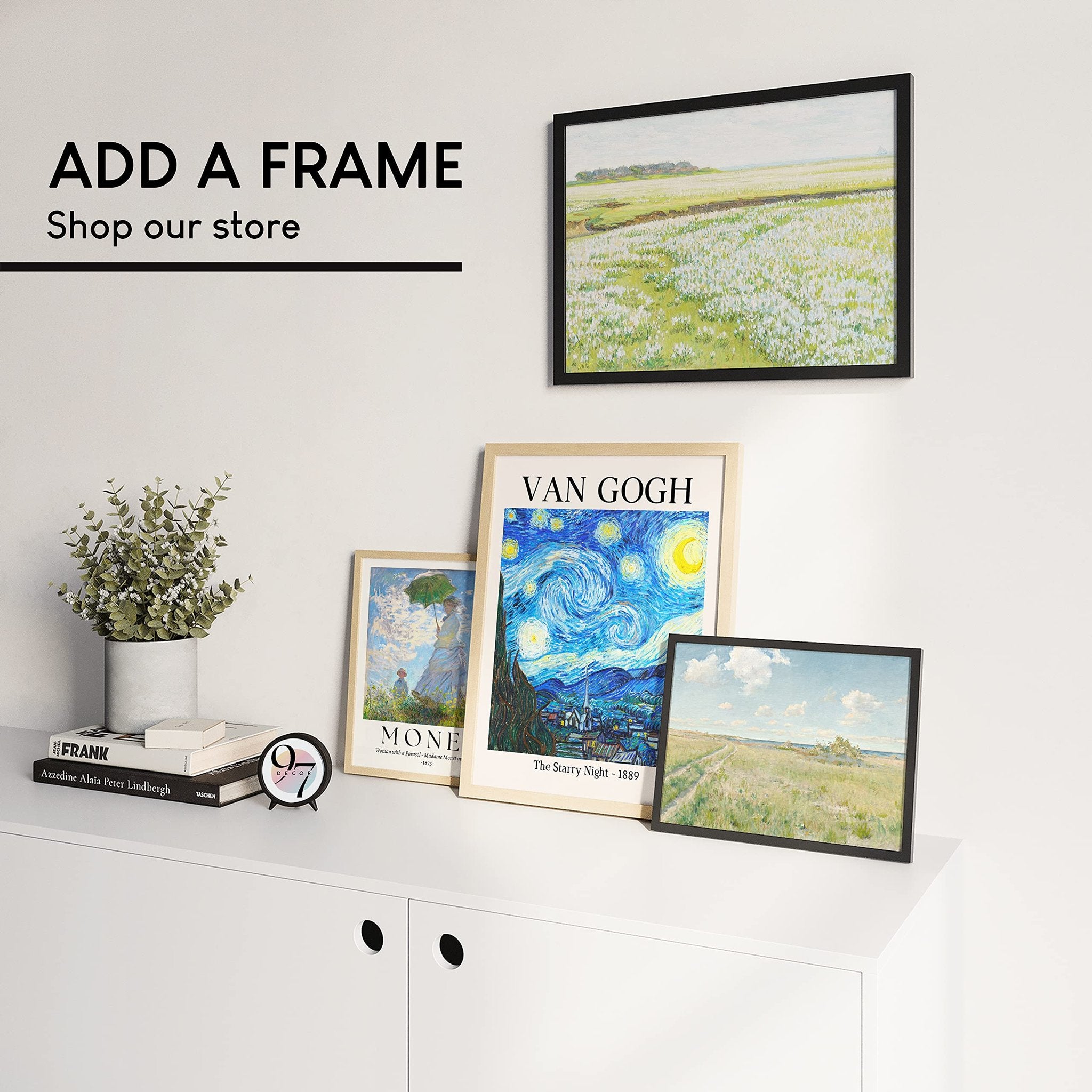 Framed art prints displayed on a wall above a white cabinet with decorative items.