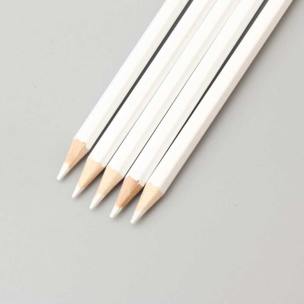 Five white wood-cased pencils with sharpened tips arranged diagonally on a gray background.