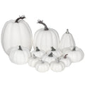 Assorted sizes of white foam artificial pumpkins arranged together on a white background.