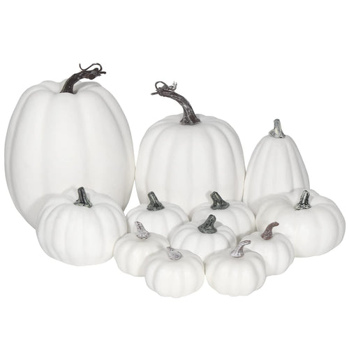 Assorted sizes of white foam artificial pumpkins arranged together on a white background.