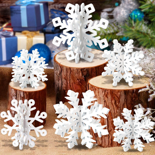 White wooden 3D snowflakes displayed on wood slices with a festive holiday background of gifts and greenery.