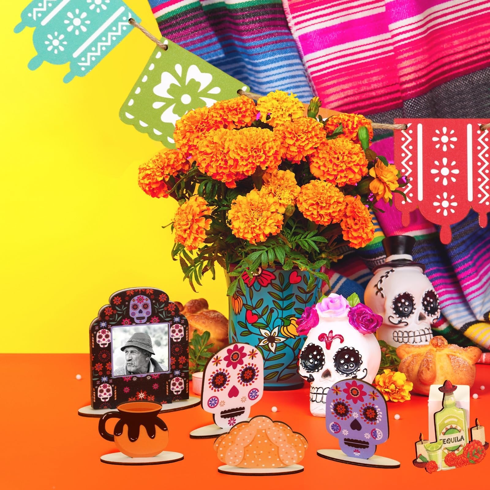 Dia de los Muertos tiered tray decor set with sugar skulls, photo frame, bread, and flowers.