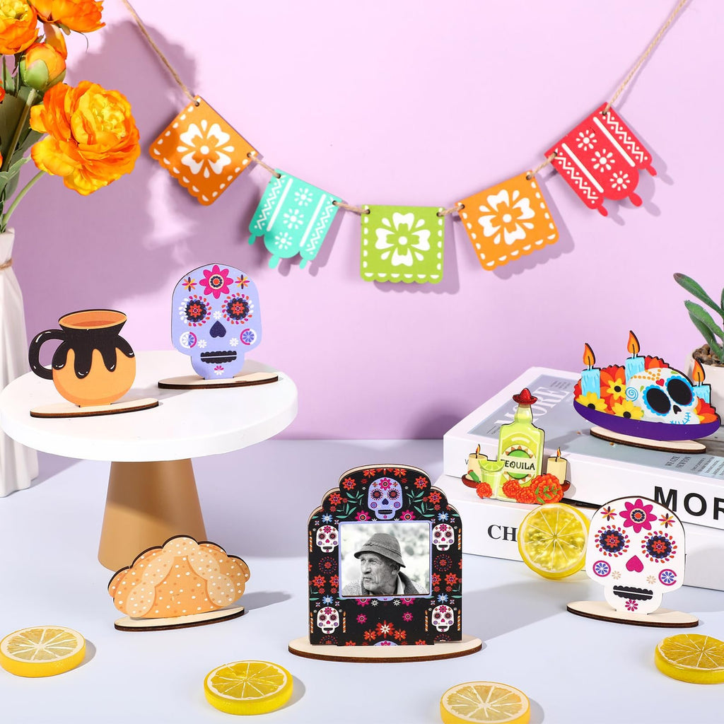 Dia de los Muertos tiered tray decor set with sugar skulls, a photo frame, and a banner on a purple background.