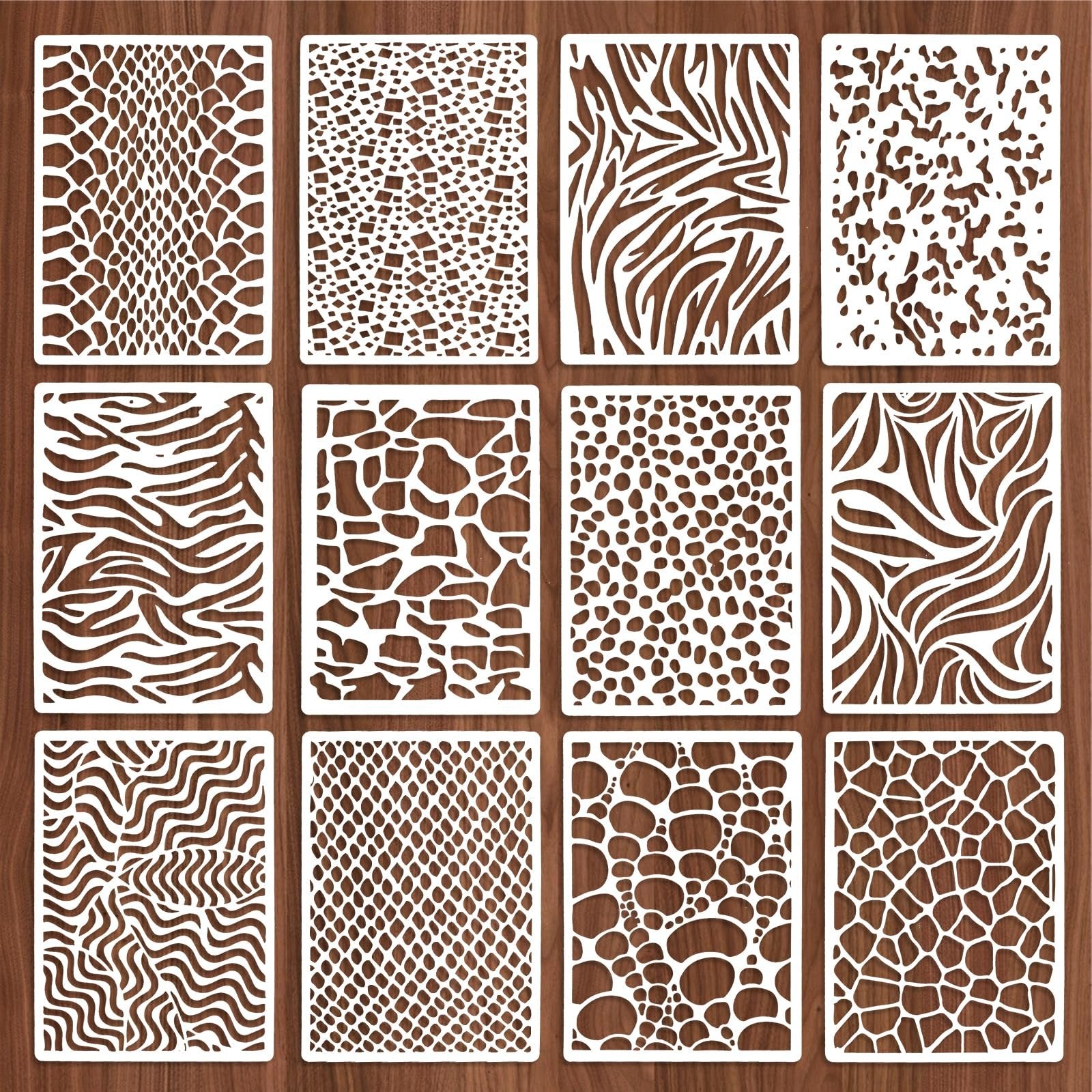 Twelve reusable stencils with assorted animal print and wavy patterns laid out on a wooden background.