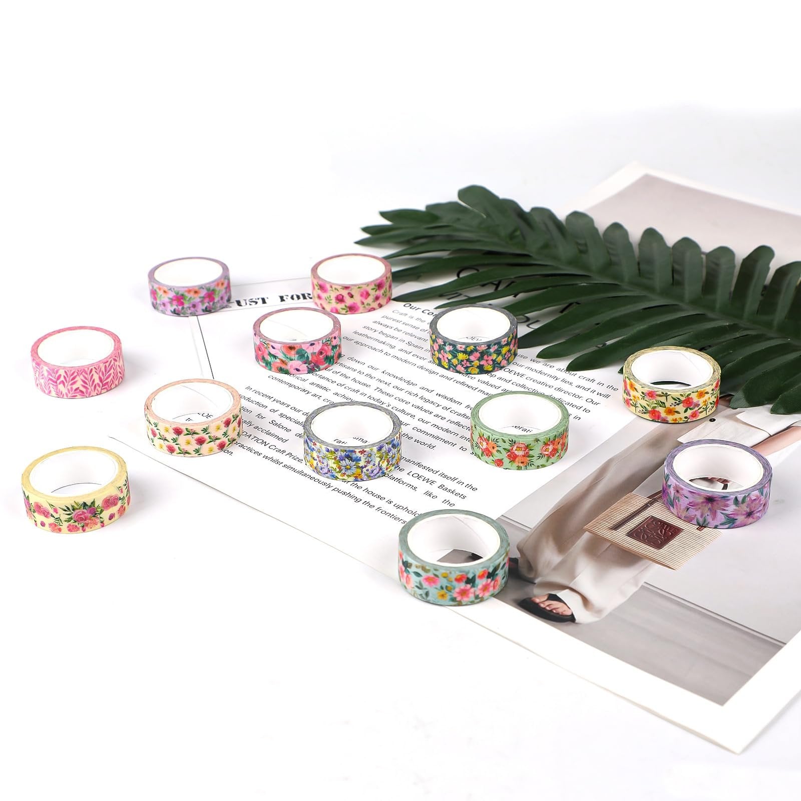 Set of 12 floral washi tape rolls arranged on a magazine with a palm leaf accent.