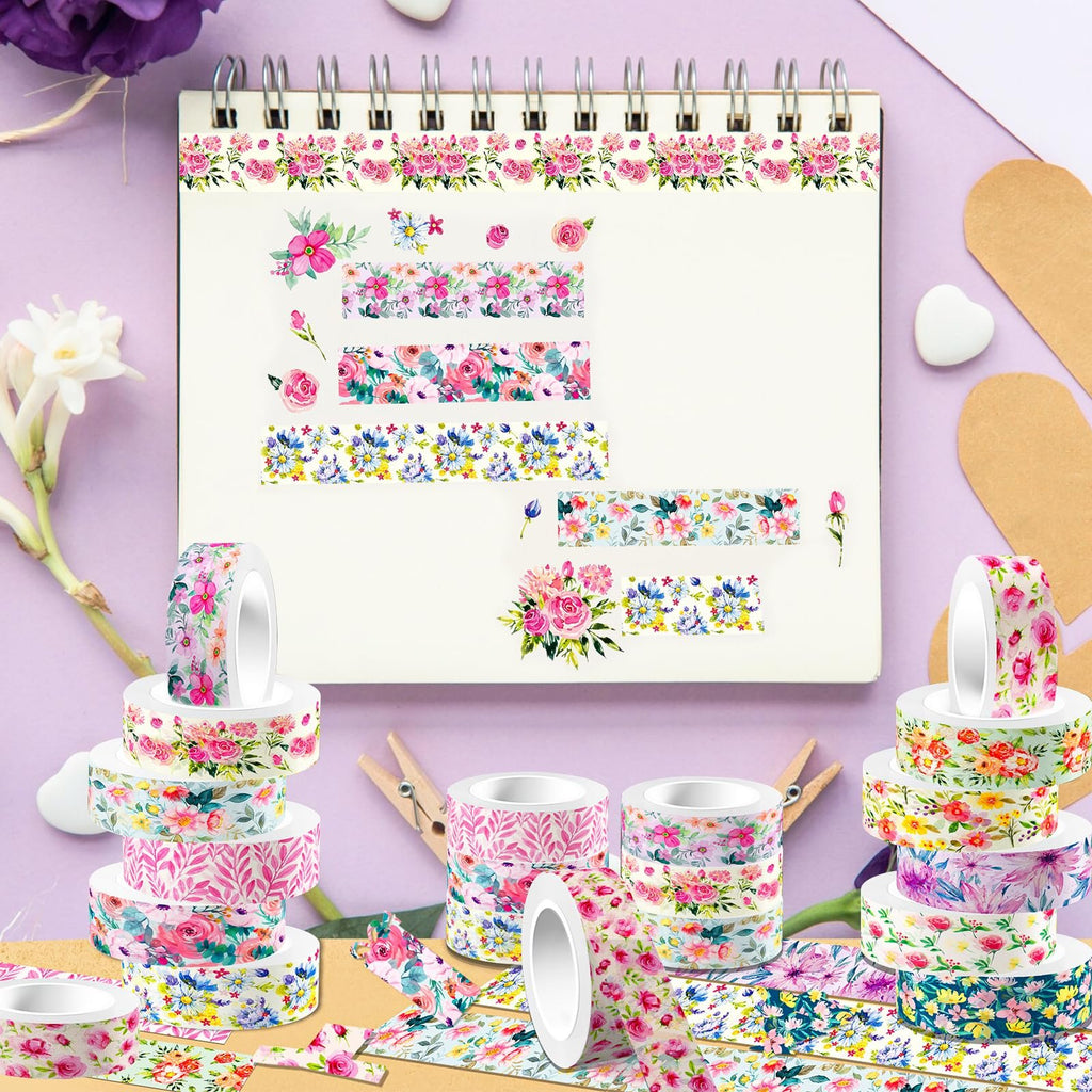 Stack of floral washi tape rolls and loose tape samples on a notebook page with floral designs.