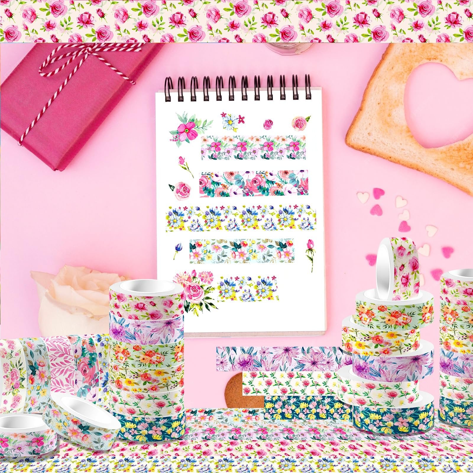 Stack of floral washi tape rolls and loose tape samples displayed with a pink gift box and a slice of toast with a heart cutout.