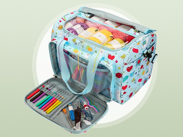 Light blue crochet storage bag filled with yarn and open to reveal crochet hooks and accessories