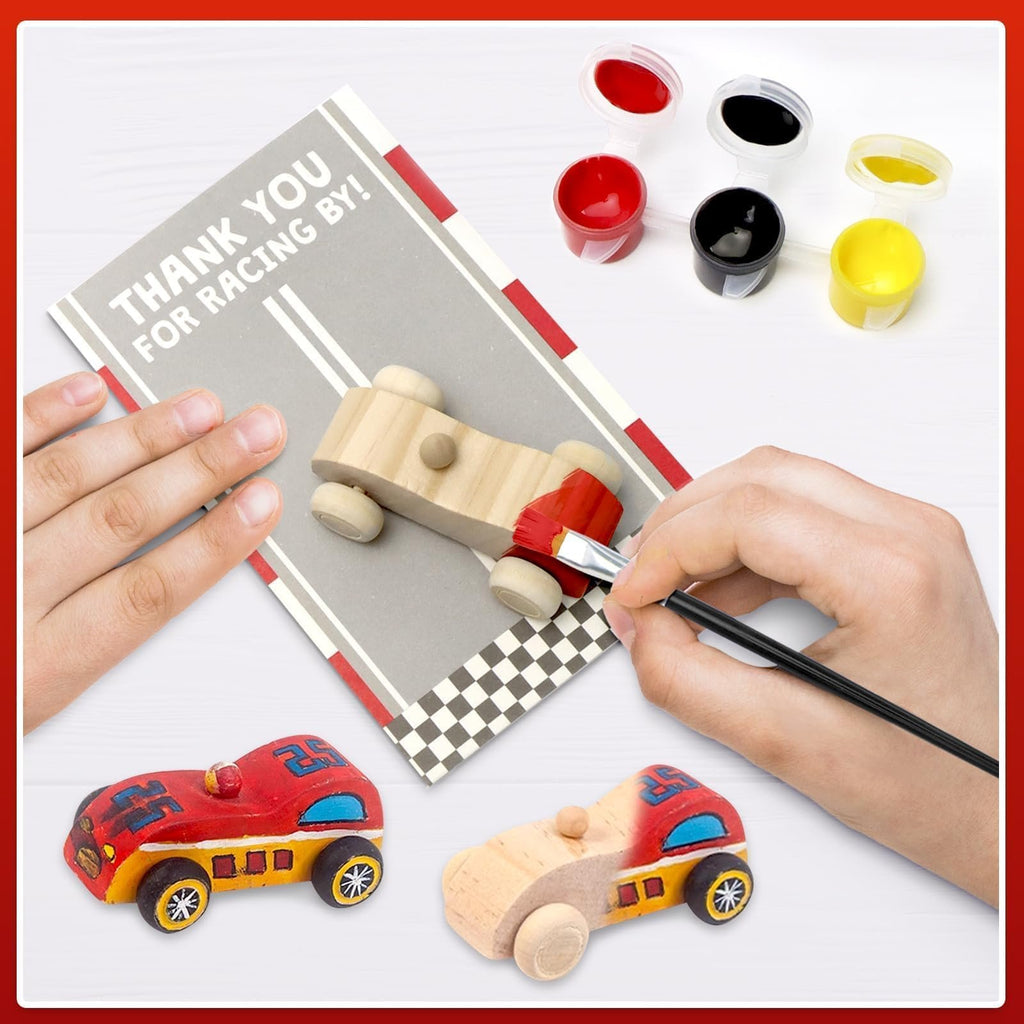 Hands painting a wooden race car kit with red and black acrylic paints and brushes.