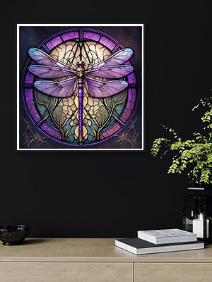 Dragonfly diamond painting art displayed on a wall above a wooden desk with books and a plant.