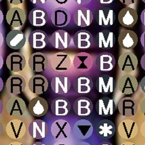 Close-up of a diamond painting canvas with symbols and letters printed on circles, with a blurred background.