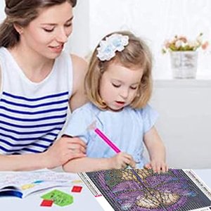 Mother and daughter doing a diamond painting kit together at a table, focusing on the canvas.