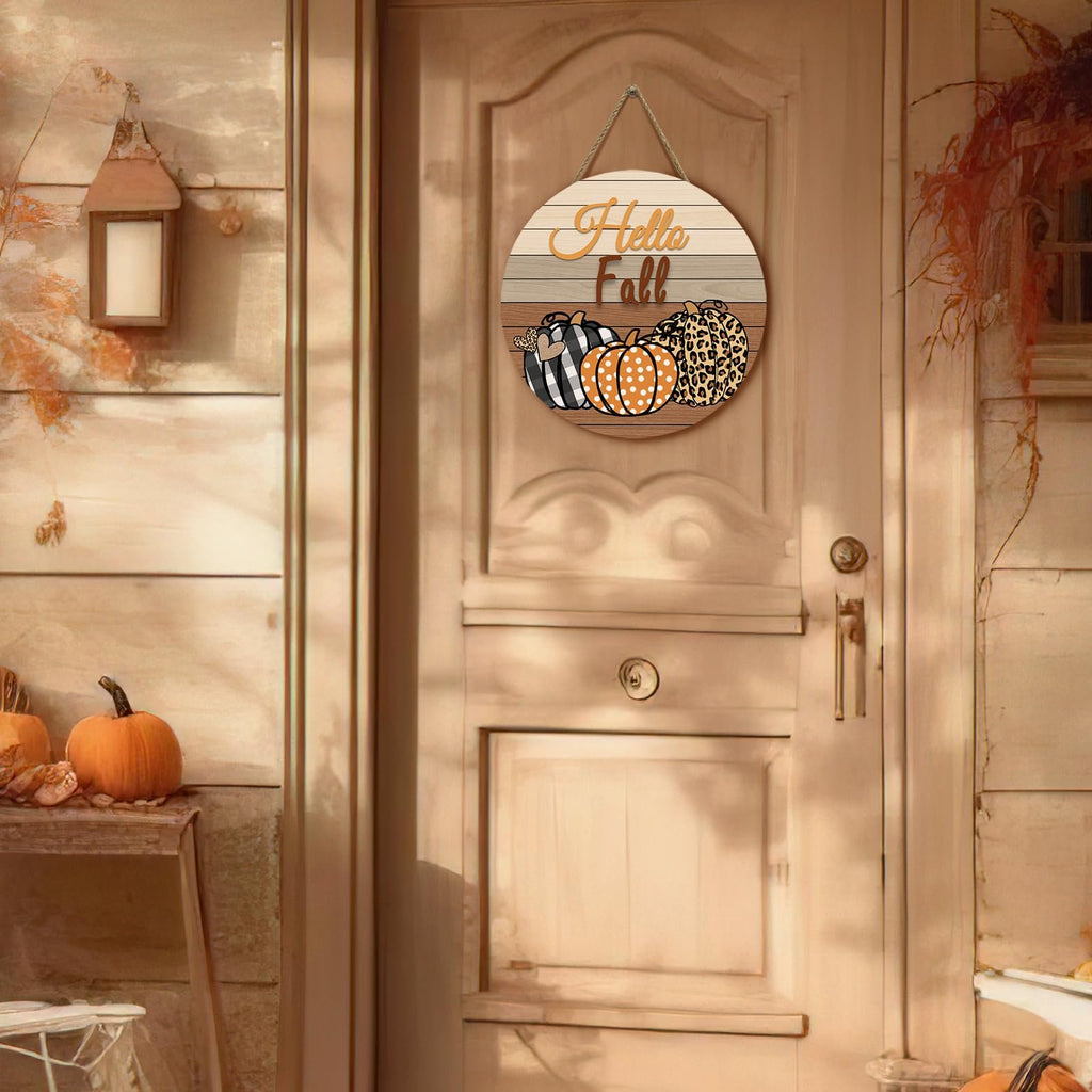 Round wooden fall door sign with pumpkins and 'Hello Fall' text hanging on a door