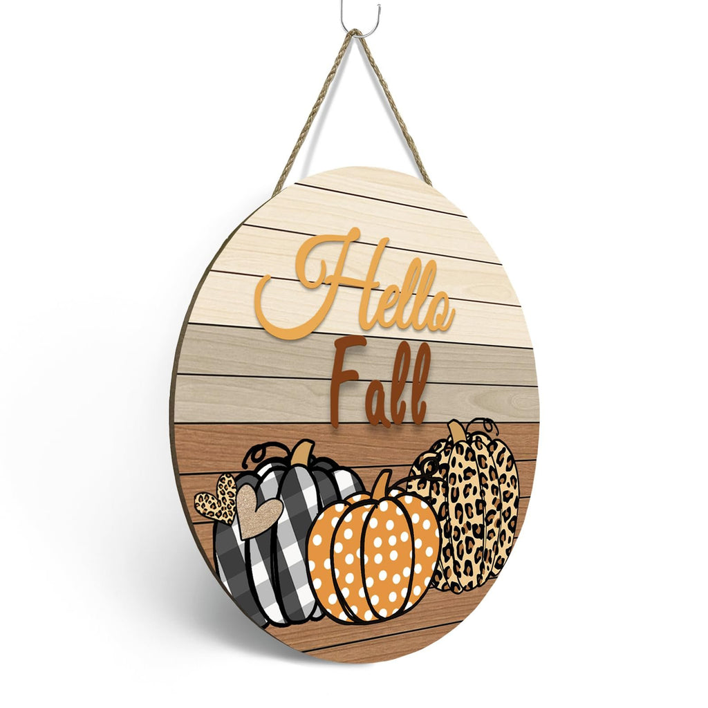 Round wooden fall door sign with pumpkins and 'Hello Fall' text, hanging by rope.