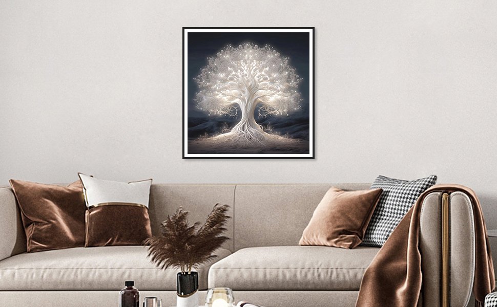 Framed 5D diamond painting of a glowing white tree of life hanging above a sofa.