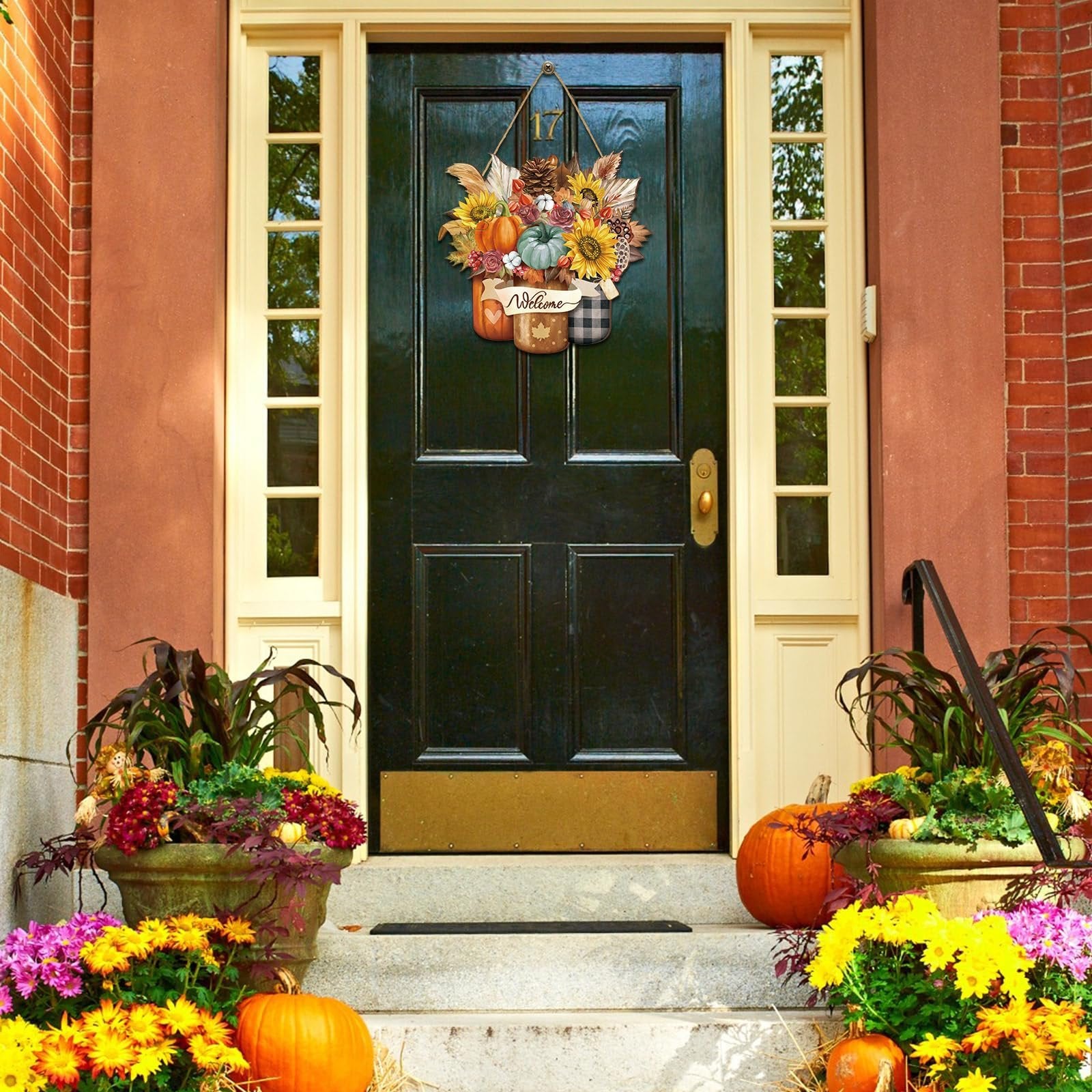 Front door decorated with a hanging fall wreath featuring pumpkins, sunflowers, and pinecones, with the word 'Welcome' on a banner.