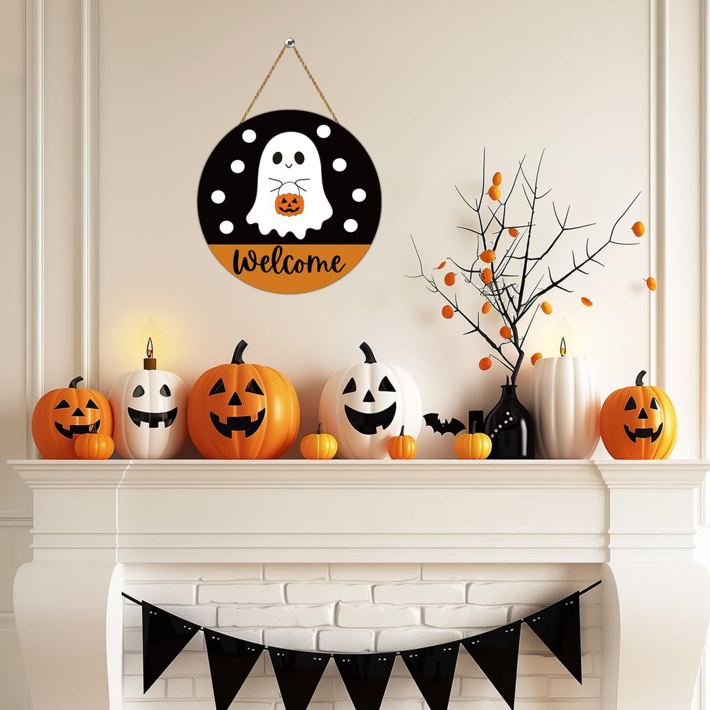 Round Halloween welcome sign with a ghost holding a pumpkin, hanging above a fireplace decorated with pumpkins and a black banner.