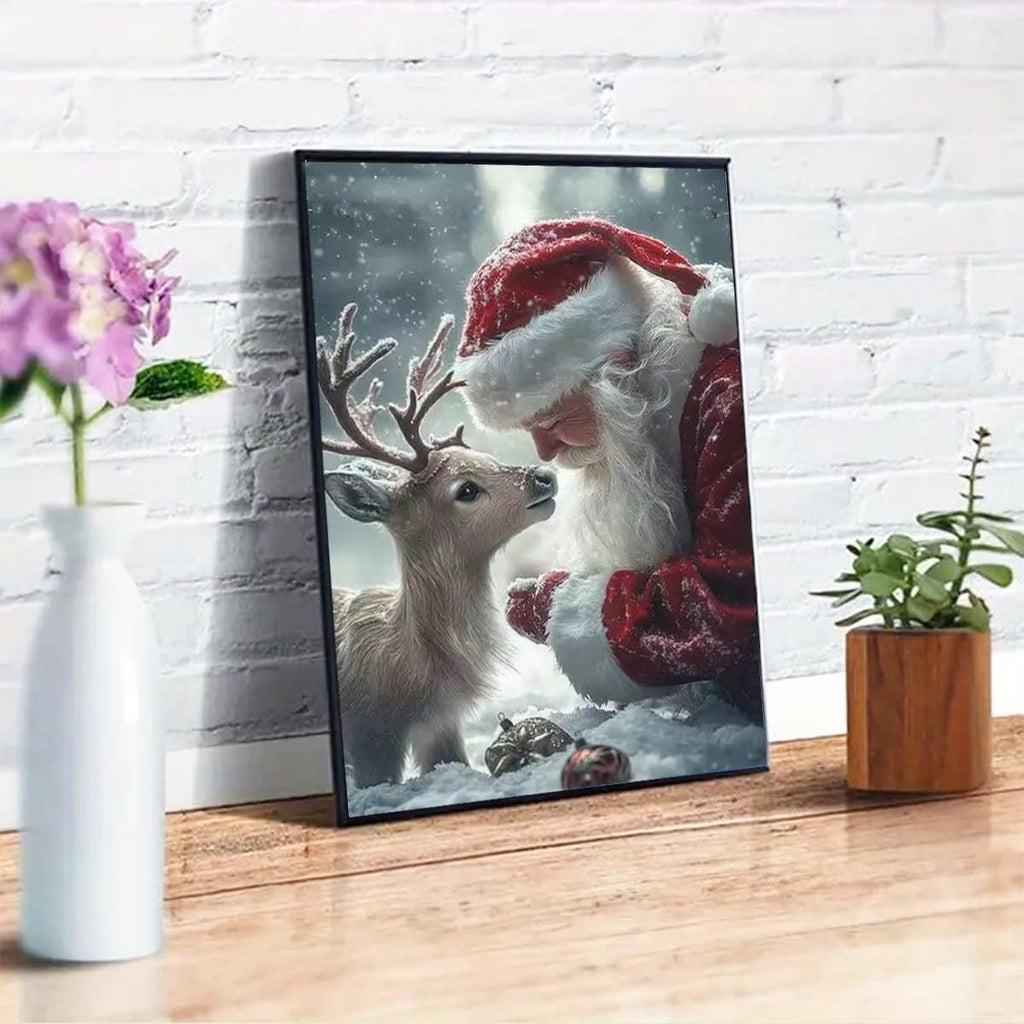 Framed 5D diamond painting of Santa Claus and a young deer in the snow, leaning in to nuzzle.
