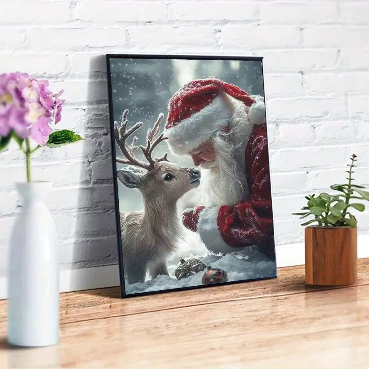 Framed 5D diamond painting of Santa Claus and a young deer in the snow, leaning in to nuzzle.