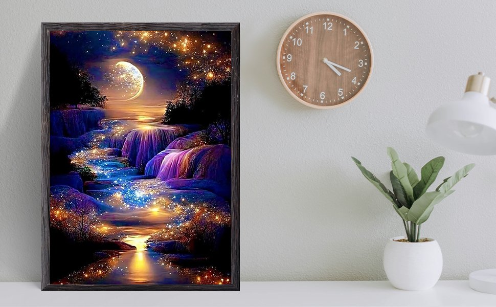 Framed diamond painting of a moonlit waterfall with sparkling lights, displayed on a wall next to a clock and plant.