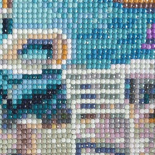 Close-up of a diamond painting kit showing a moon and waterfall scene with blue, green, and brown beads.