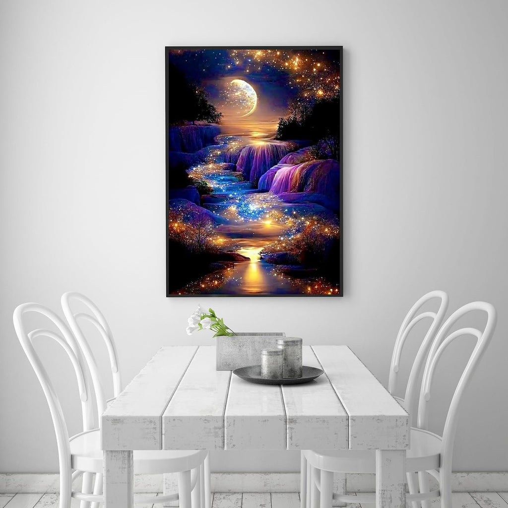 Diamond painting of a moonlit waterfall with sparkling lights, framed and hanging above a white dining table.