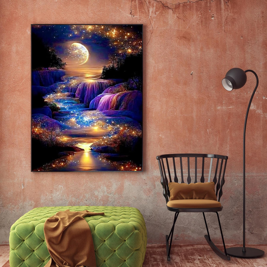 Diamond painting of a moonlit waterfall with sparkling lights, displayed on a wall above a green ottoman and next to a chair.