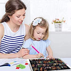 Mother and daughter doing a diamond painting kit on a table, with the kit laid out.