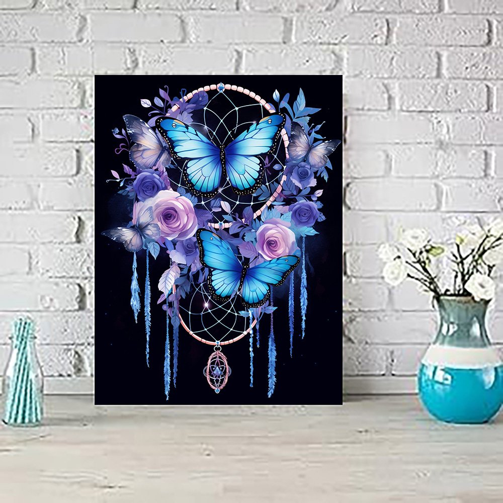 Diamond art painting kit featuring blue butterflies and purple roses on a dreamcatcher, displayed on a shelf.
