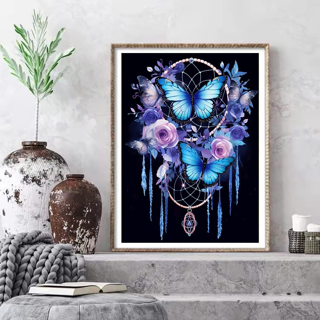 Diamond art kit featuring a dream catcher with blue butterflies and purple roses against a black background.