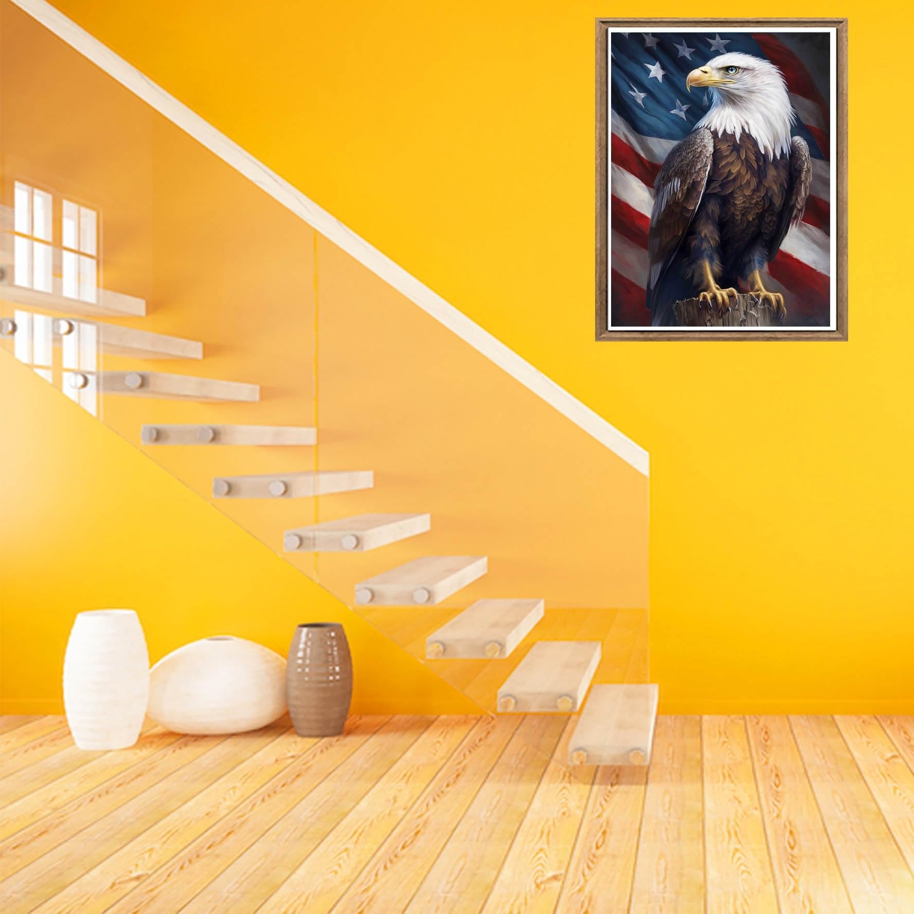 Framed diamond painting of an eagle perched before an American flag, displayed on a yellow wall above a modern staircase and decorative vases.