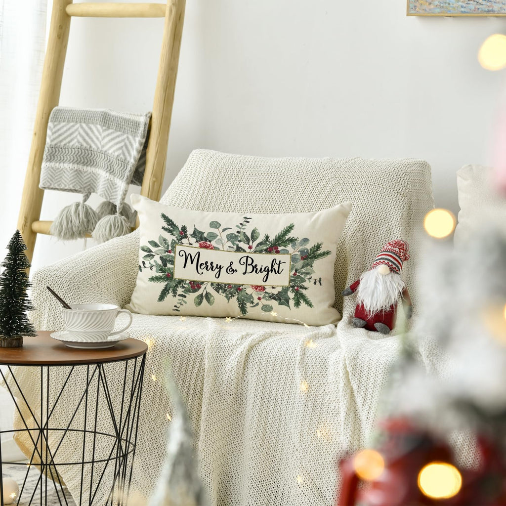 Christmas eucalyptus mistletoe throw pillow cover with 'Merry & Bright' text on a couch with a gnome and blanket