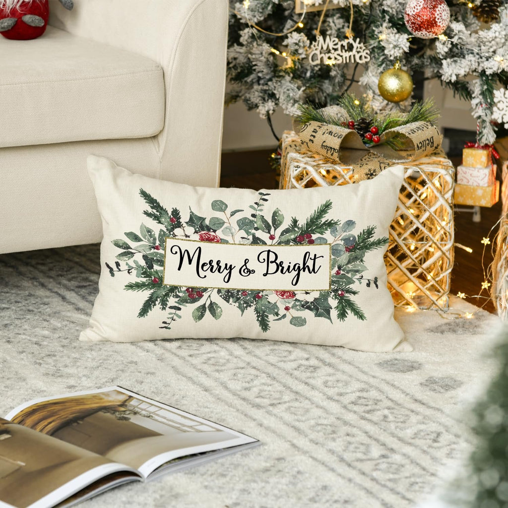 Christmas eucalyptus mistletoe throw pillow cover with 'Merry & Bright' text, placed on a rug near a decorated Christmas tree and gifts.