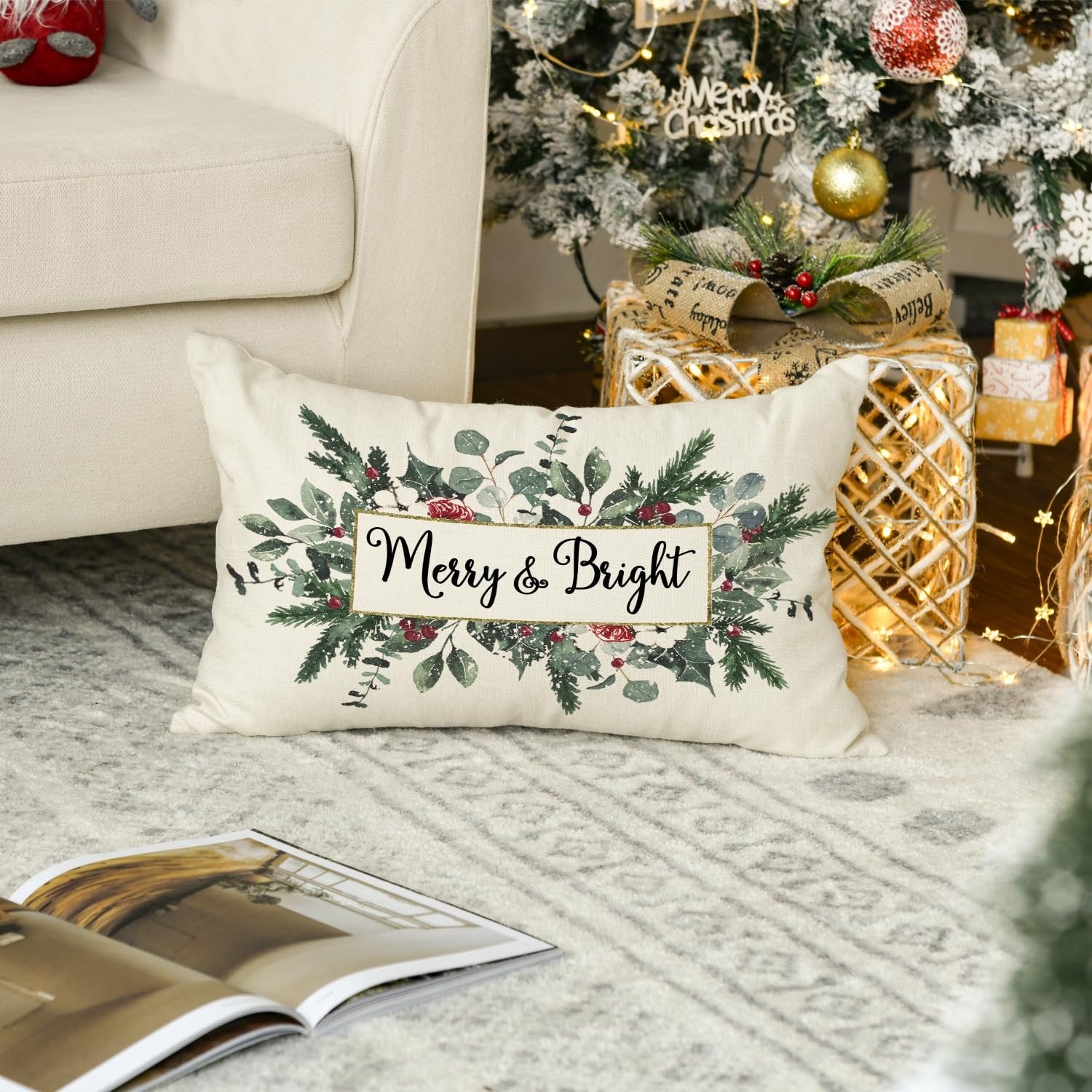 Christmas eucalyptus mistletoe throw pillow cover with 'Merry & Bright' text, placed on a rug near a decorated Christmas tree and gifts.