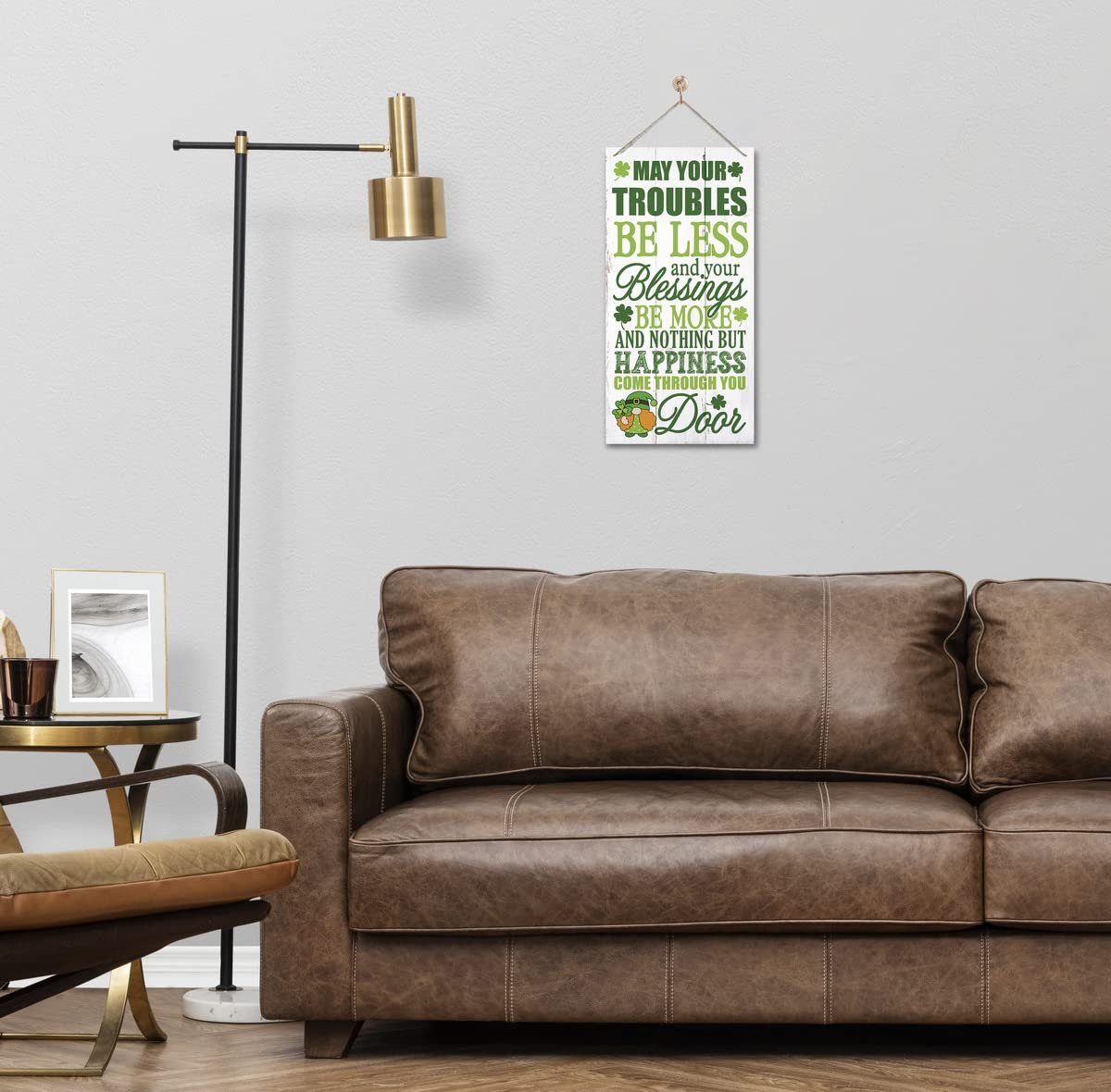Saint Patrick's Day wooden sign with Irish prayer hanging on a wall above a leather sofa.