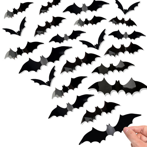 Black 3D bat wall decals in various sizes, with a hand placing one on a surface.