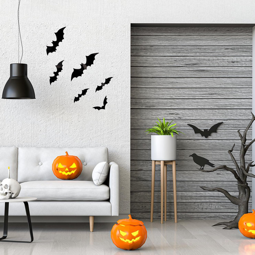 Halloween scene with black bat wall decals on a white wall, jack-o'-lanterns, a skull candle holder, and a plant on a stand.