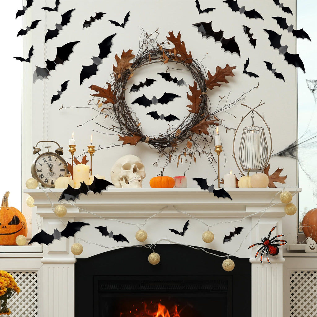 Halloween fireplace mantle decorated with black bat wall decals, a twig wreath, pumpkins, candles, and string lights.