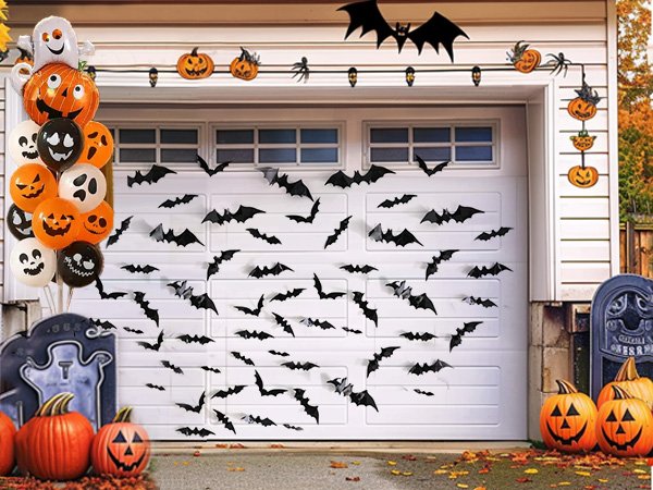 Halloween decorations including black bats, pumpkins, and ghost balloons on a garage door and surrounding area.