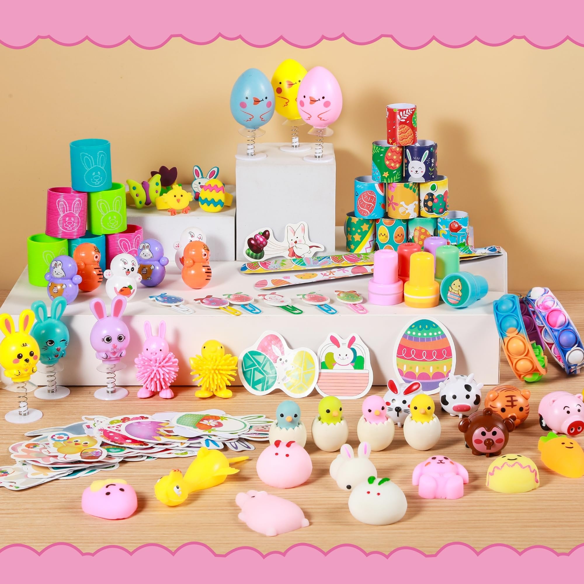 Easter toy assortment including spring-loaded characters, squishies, stampers, and pop-it bracelets