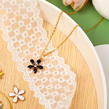Gold-plated zinc alloy flower charms and necklace on white lace trim