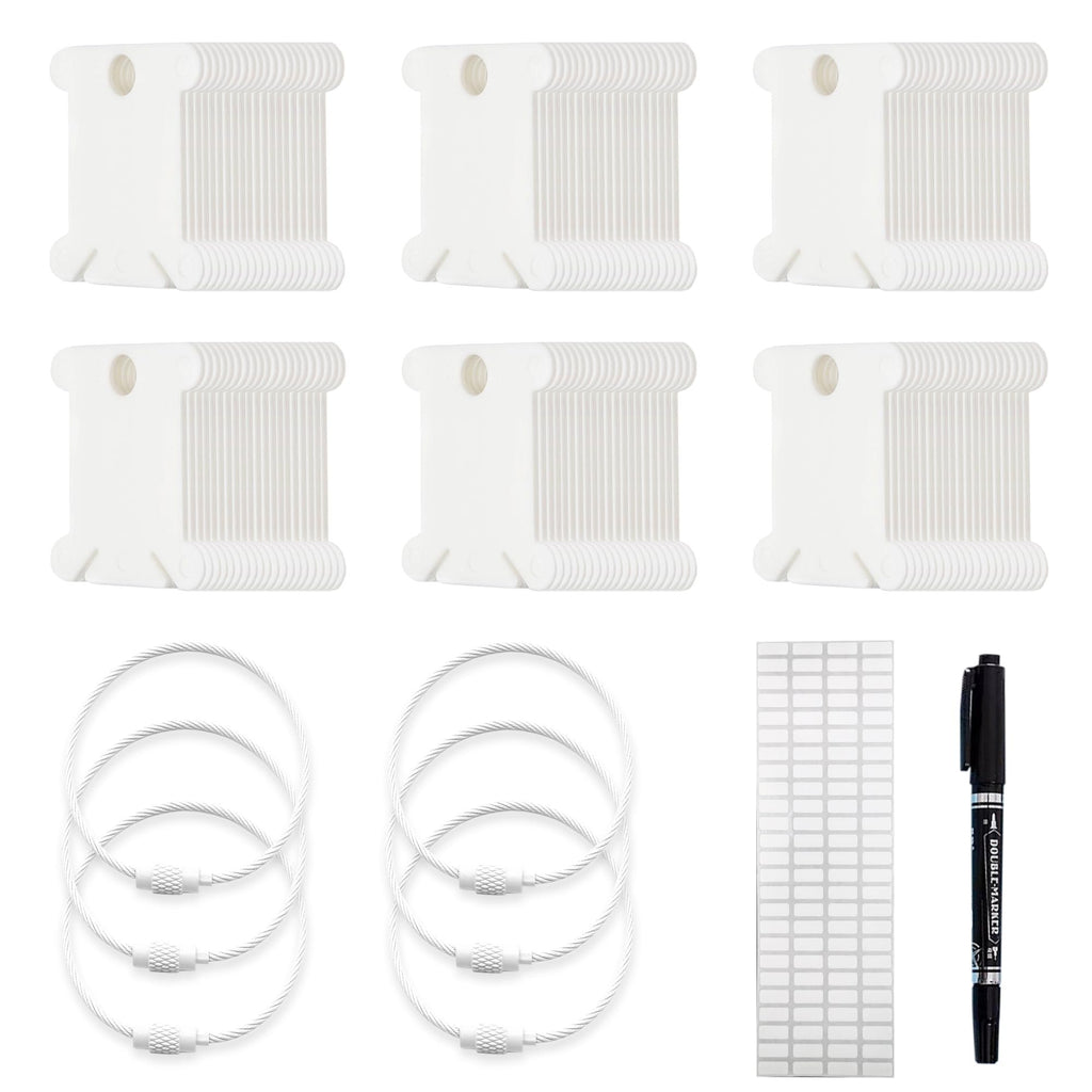 Set of white plastic embroidery floss bobbins, metal storage rings, labels, and a black marker pen on a white background.