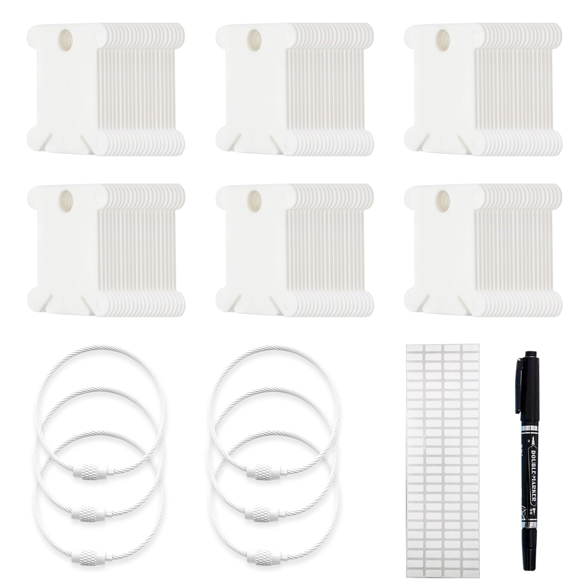 Set of white plastic embroidery floss bobbins, metal storage rings, labels, and a black marker pen on a white background.