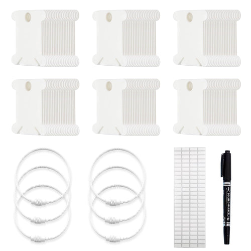 Set of white plastic embroidery floss bobbins, metal storage rings, labels, and a black marker pen on a white background.