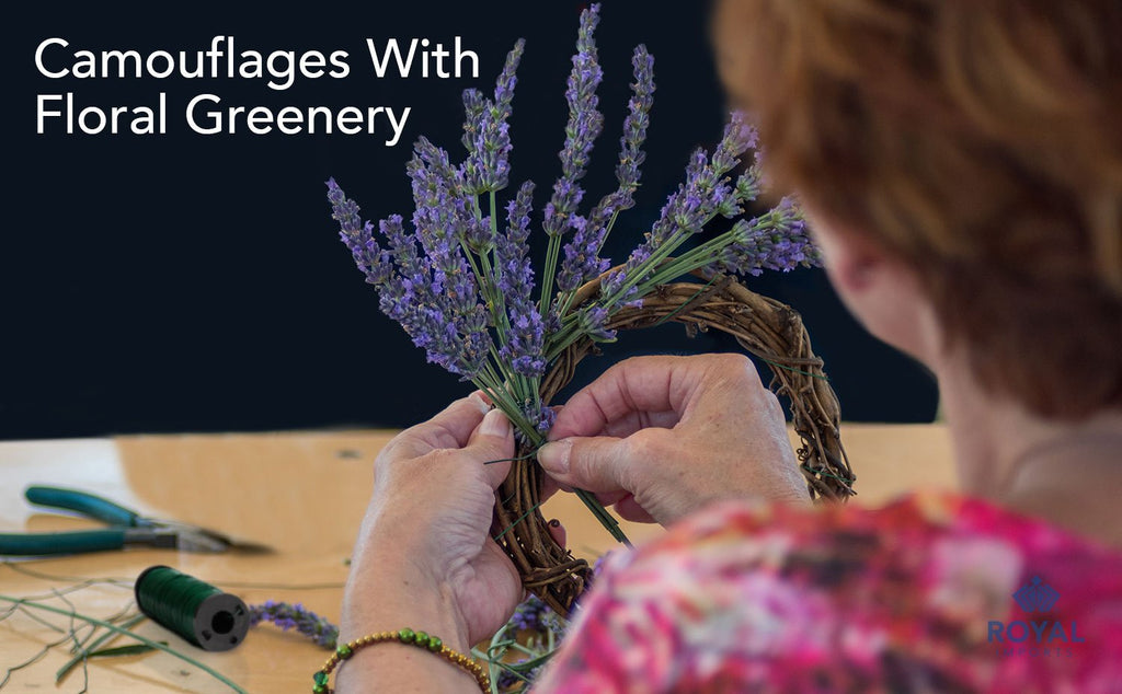 Hands crafting a wreath with lavender and floral greenery, using green paddle wire spool.