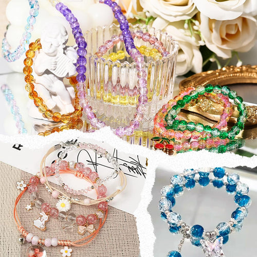 Assorted colorful glass beads and finished bracelets arranged with decorative elements and flowers.