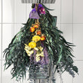 Dried eucalyptus and lavender bouquet hanging from a shower head with small sachets.