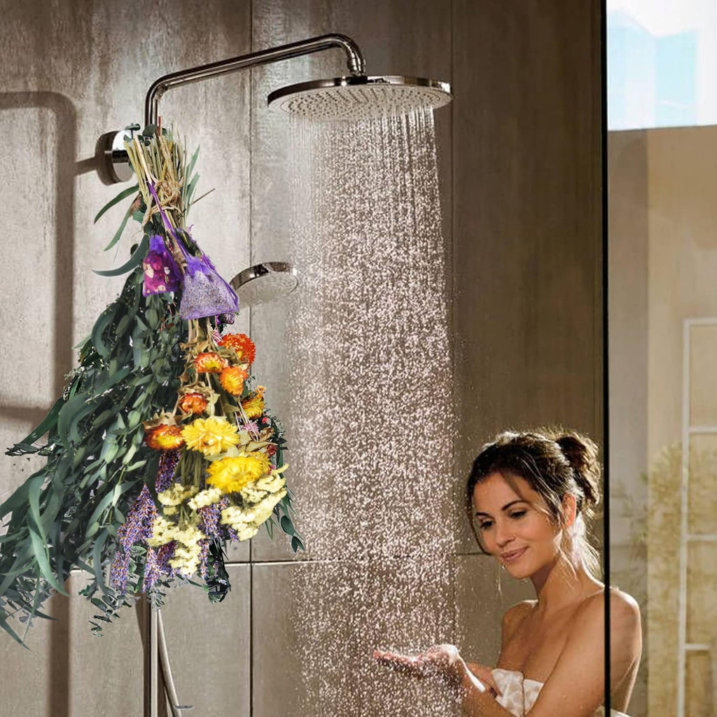 Dried eucalyptus and lavender bouquet hanging in a shower with a woman holding her hand under the water.