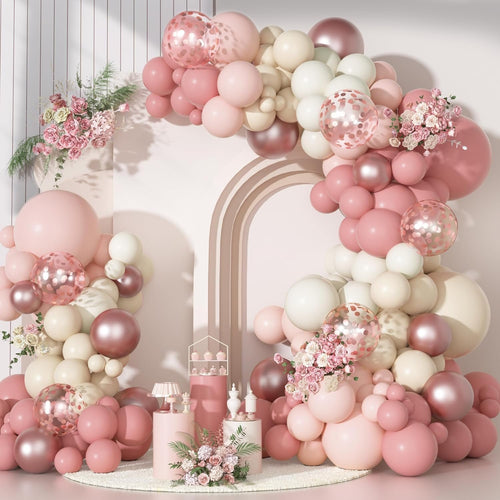 Dusty pink balloon arch garland kit with various sizes of latex, confetti, and metallic balloons, accented with floral arrangements.