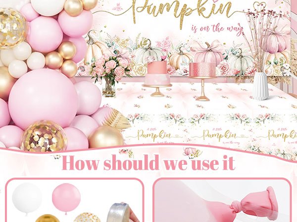 Pink and gold balloon garland arch with pumpkins and floral decorations for a baby shower